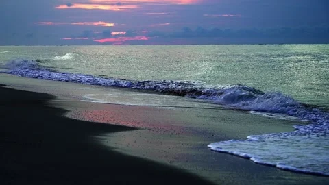 Calm ocean waves crashing on sandy beach at sunset Stock Footage 341361168