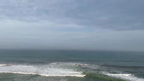 Calm Ocean Waves Crashing Under a Cloudy Sky Stock Footage 340256557