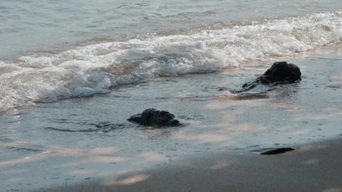 Calm Ocean Waves Gently Lapping Against Rocky Shoreline Stock Footage 296480140