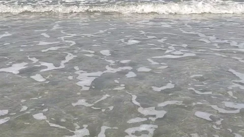 Calm ocean waves gently washing onto the shore creating serenity Stock Footage 322096100
