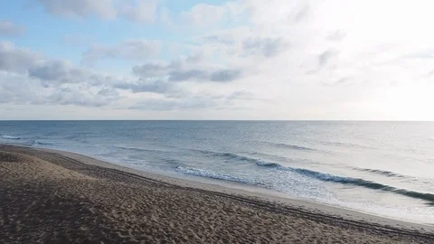 Calm Ocean Waves Roll Onto The Beach at Sunrise Stock Footage 90808815