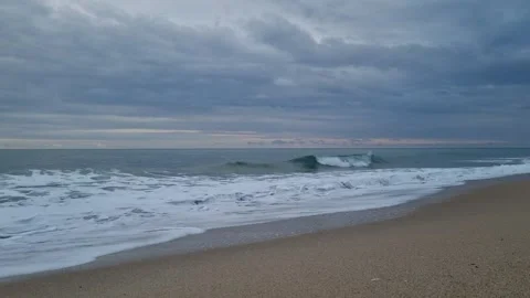 Calm Ocean Waves Rolling on Beach Under Cloudy Morning Sky Stock Footage 320253699