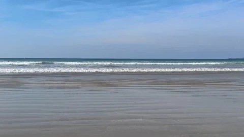 Calm ocean waves rolling onto sandy beach in Brittany France Video stock 334299183