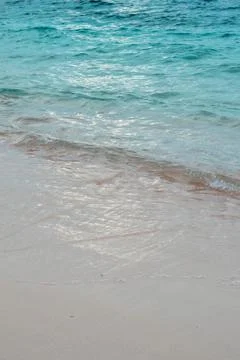 Calm Ocean Waves on Sandy Beach Stock Photos