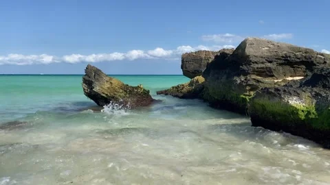 Calm ocean waves splashing on the rocks at Playa del Carmen Beach Stock Footage 246743612