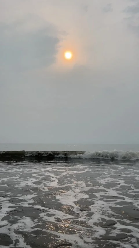 Calm ocean waves at sunrise with small fishing boat Stock Footage 335108345