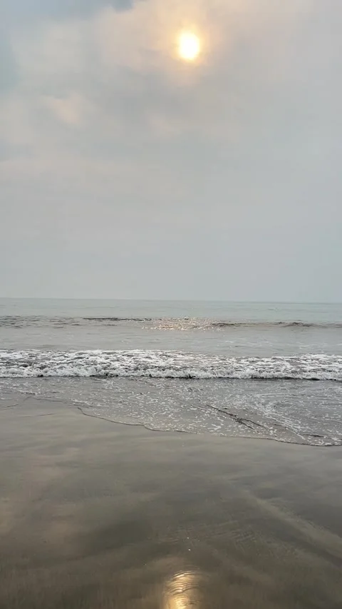 Calm ocean waves at sunrise with small fishing boat Stock Footage 335108346