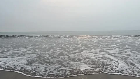 Calm ocean waves at sunrise with small fishing boat Stock Footage 335108383