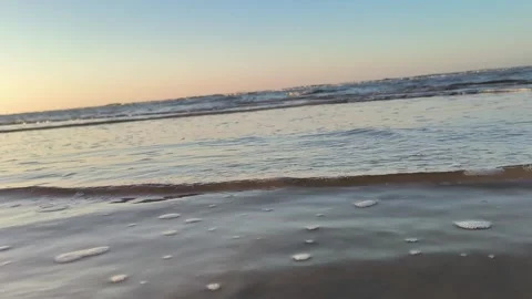 Calm Ocean Waves at Sunset Beach Low Angle Shot Stock Footage 340215894