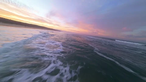 Calm ocean waves at sunset with gentle surf and vibrant sky Stock Footage 344542890