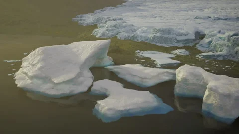 Calm oceanfront landscape with scattered ice chunks and tranquil water surface Stock Footage 341566584