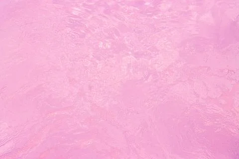 Calm, pink water surface with subtle waves and a dreamy, ethereal quality Photos