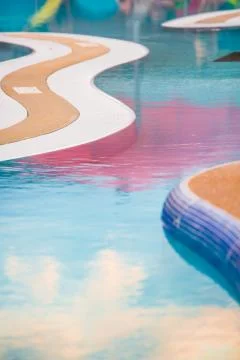 Calm pool surface with umbrella reflections Stock Photos