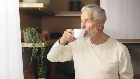 Calm relaxed senior gray haired man with cup of hot coffee or tea enjoying Stock Footage 253513693