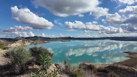 Calm Reservoir Lake with Cloud Reflections in Mountain Landscape Video stock 330466523