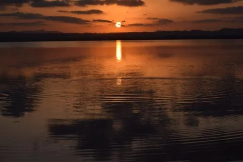 Calm ripples on a lake at sunset 写真素材