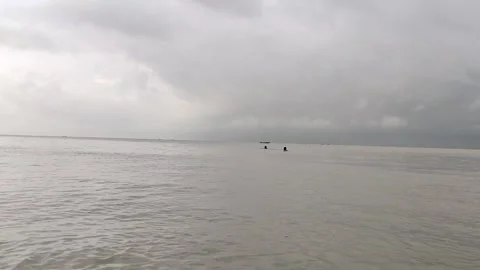 Calm River and Dramatic Cloudy Sky with Distant People – 4K Static Footage Stock Footage 338343301