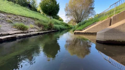 Calm River Flowing Between Grassy Banks 動画素材 318098606