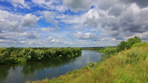 A calm river flows through the plain in a bright sunny day Video stock 74516855