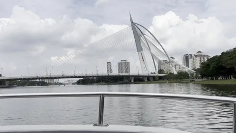 Calm river flows under bright, partly cloudy skies Stock Footage 340034306