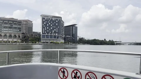 Calm river flows under bright, partly cloudy skies Stock Footage 340034453
