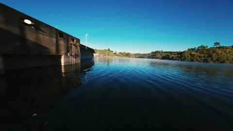 Calm river flows under clear blue sky at Castelo de Bode Stock Footage 342272685