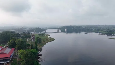 Calm river flows under an overcast sky Stockbeeldmateriaal 344816970