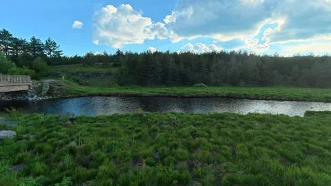 Calm river flows under a stone bridge. Rzav River (Zlatibor), Serbia. Stock Footage 337122405