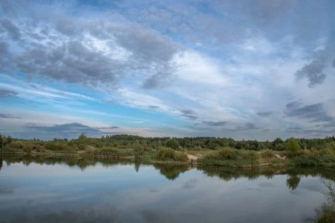 Calm River Landscape with Dramatic Cloudy Sky Reflection 스톡 사진