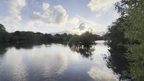 Calm river reflecting cloudy sunset 4K 库存影片 335541789