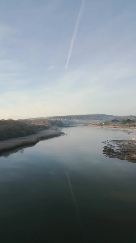 A calm river with a reflection of the sky and clouds Stock Footage 298291789