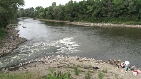 Calm river scene with flowing water and fishermen Stock Footage 336201245