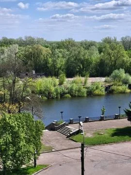 Calm River Surrounded by Spring Trees Stock Photos