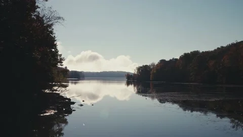 Calm river with trees and mountains clouds in sky Video stock 165766939