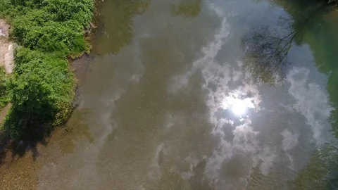 Calm river water reflects sunlight reaches dam falls down Stock Footage 101741443