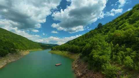 Calm river winds through emerald forested hills. Zavoj Lake, Serbia Stock Footage 337493713