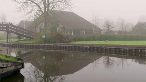 Calm Rural Setting Showcasing Arched Wooden Bridge And Scenic Reflections Video stock 325453191