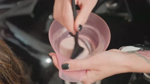 Calm salon environment with precise hair dye preparation process, Stylish salon Stock Footage 329448321