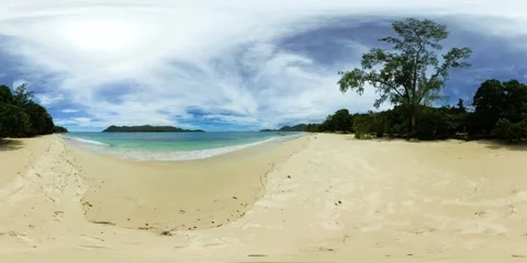 A calm sandy beach under a wide open sky. Praslin, Seychelles. Stock Footage 311037598