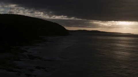 Calm sea and mountain on side during sunrise Stock Footage 81000072