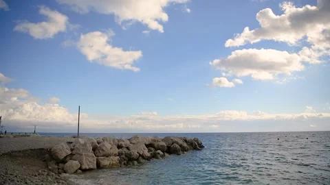Calm sea blue sky with clouds and small stone dock 動画素材 164533692