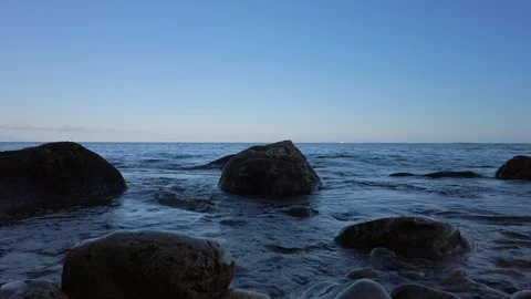 Calm Sea Lapping Rocks Stock Footage 124862807