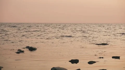 Calm sea with a slight ripple at sunset Stock Footage 81440368