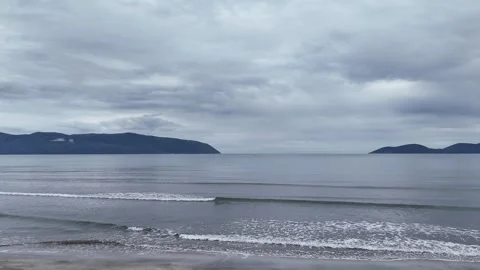 Calm sea with small waves under cloudy sky wide drone shot Stock Footage 332559740