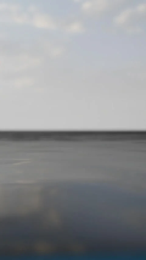 Calm sea stretches under clouds at dusk near shore in tropical location Stock Footage 340279122