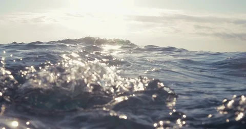 Calm sea surface in slow-motion from underwater with sun rays going through Stock Footage 88854925