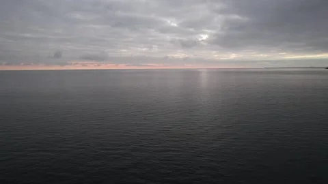 Calm sea under cloudy sky at sunset, dark dramatic clouds Video stock 166597158