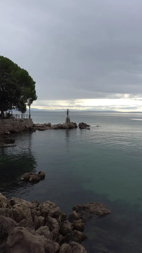 Calm sea view with a small lighthouse and rocky shore. Stock Footage 312517982