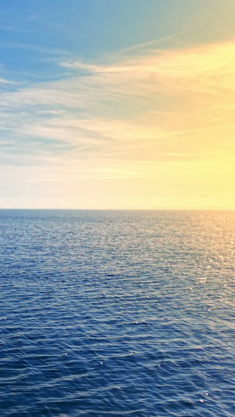 Calm sea water surface at sunset with bright sky Vertical video. Stock Footage 332344374