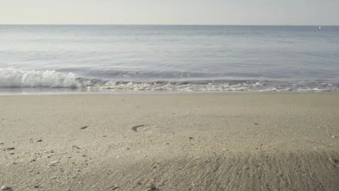 Calm sea wave splashing on a clean sandy beach shore at daytime Stock Footage 342446129